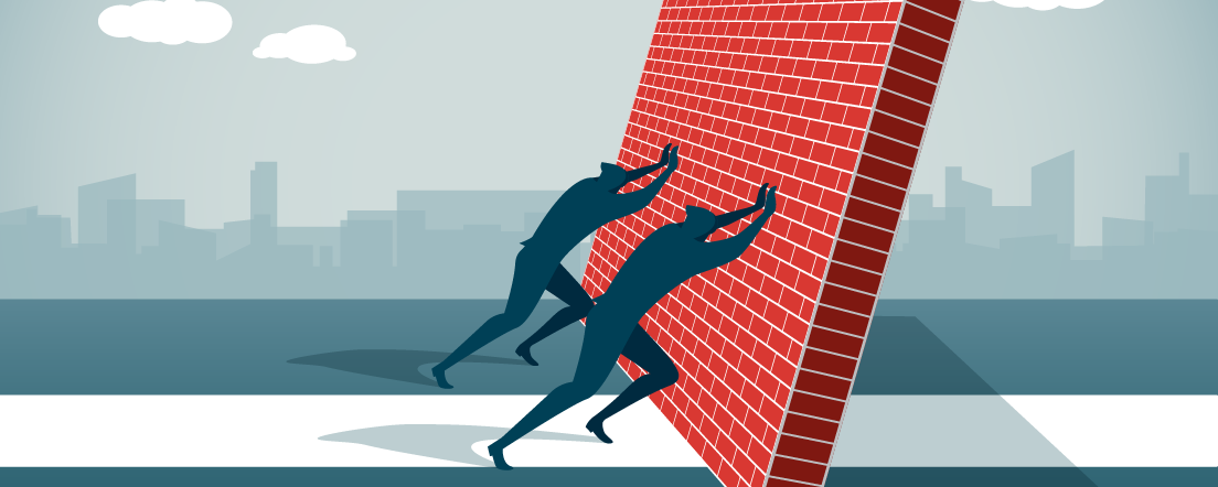 Two silhouetted figured push over brick wall