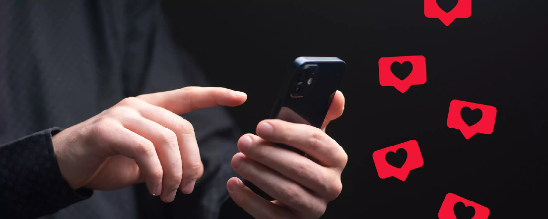 Hands holding a phone while with heart emojis floating around it